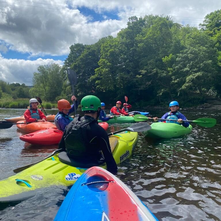 Coaching 3 Kayakers enjoying a scenic river outing.